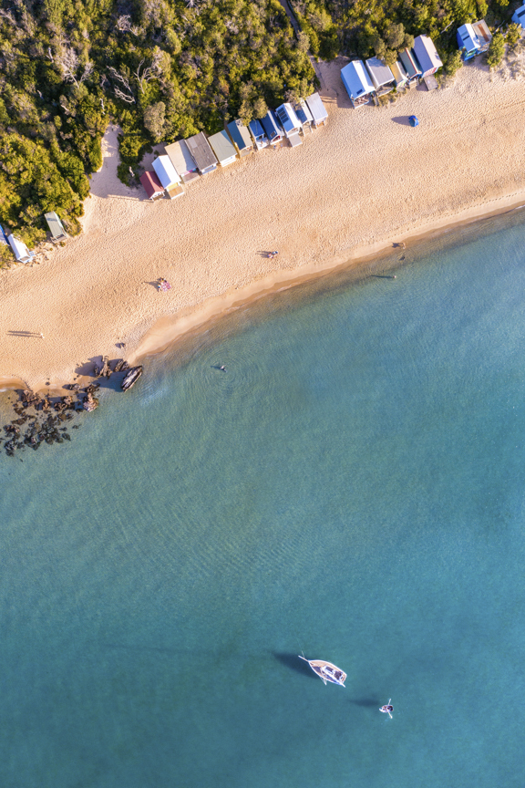 Blue Lagoon is an Aerial Photograph of a yacht anchored of Mills Beach on the Mornington Peninsula